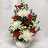 White spider mums and red carnations in a white vase