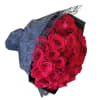 Bouquet of red roses wrapped in dark paper