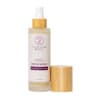 Bottle of bloom spray with a gold cap on a white background