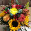 A sweet mix of sunflowers, dahlias, solidago, and other harvest greens. Put