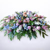 Large pastel floral spray with pink and lavender roses and blue flowers