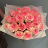 Bouquet of pink roses wrapped in pale paper