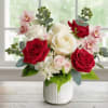 Red and white roses with pink orchids in a white vase