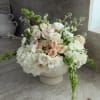 White hydrangeas, blush and peach roses, lisianthus and green stock in a