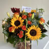 Bouquet of sunflowers and orange roses in a wooden box