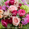 Mixed bouquet of pink, magenta, and lavender flowers with roses and ranunculus
