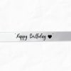 White ribbon with "Happy Birthday" text and a heart
