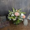 Pink and white floral arrangement in a glass vase