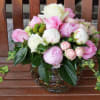Pink and white flower arrangement in a glass vase