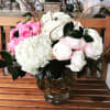 Pink roses and white hydrangeas in a glass vase