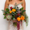 Bride holding a bouquet with orange flowers and succulents
