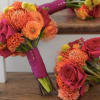 Two pink and orange bridal bouquets with roses and mums