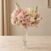 Pink and white rose bouquet in a tall clear glass vase