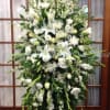 Large white floral standing spray on an easel