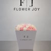A delicate arrangement of soft pink and ivory roses, beautifully presented in