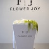 A refined arrangement of creamy white blooms accented with cascading green amaranthus