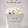 A timeless arrangement of fresh white roses, elegantly presented in a signature