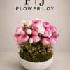 A soft and elegant arrangement of pink and white ranunculus, fresh tulips