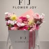 Pink and white flower bouquet in a white gift box with ribbon