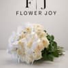A graceful arrangement of ivory roses and delicate white orchids, finished with