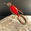 A bold sculptural flourish, this unique standing sculpture features a metal and