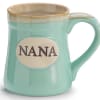 Mint green ceramic mug with the word "NANA" on a cream oval plaque.