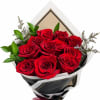 Bouquet of red roses with green foliage in black and white wrap