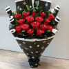 Bouquet of red roses wrapped in black patterned paper