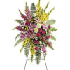 Standing floral spray with pink, yellow, and white flowers on an easel