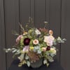 Mixed bouquet in a ribbed vase with burgundy, blush, and cream flowers