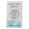 Enamel pin on a card with hands holding the Earth and the words Love the Earth