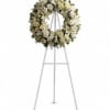 White floral wreath on a standing easel