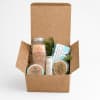 Gift box with bath salts, balm, and other self-care items