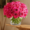 Bouquet of bright pink roses in a clear glass vase