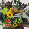 Mixed bouquet with sunflowers, orange blooms, and green hydrangea