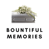 White floral spray on a silver casket