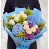 Bouquet of blue hydrangeas, white roses, and purple carnations wrapped in blue paper