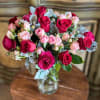 Bouquet of pink and red roses in a clear glass vase