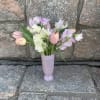 Pastel tulips and sweet peas in a lavender vase