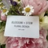 Pink and white flowers with a gift card in the center