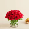 Red roses arranged in a clear glass vase