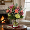 Bouquet of pink and coral flowers in a clear glass vase