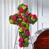 Vibrant sympathy cross featuring fresh roses, green button chrysanthemums, carnations, and seasonal