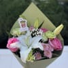 A Mix of pink, green and white blooms, topper included , in