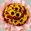 Bouquet of yellow sunflowers and red roses wrapped in pink paper