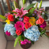 Cheerful colors and textures, high quality blooms gathered with greens bring a