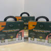 Three houseplant care kits in dark green and orange boxes.