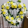 Heart-shaped floral wreath with white daisies and yellow carnations