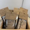 Assorted air freshener packets in a wooden tray