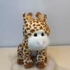 Plush giraffe toy with brown-and-white spots and a white snout